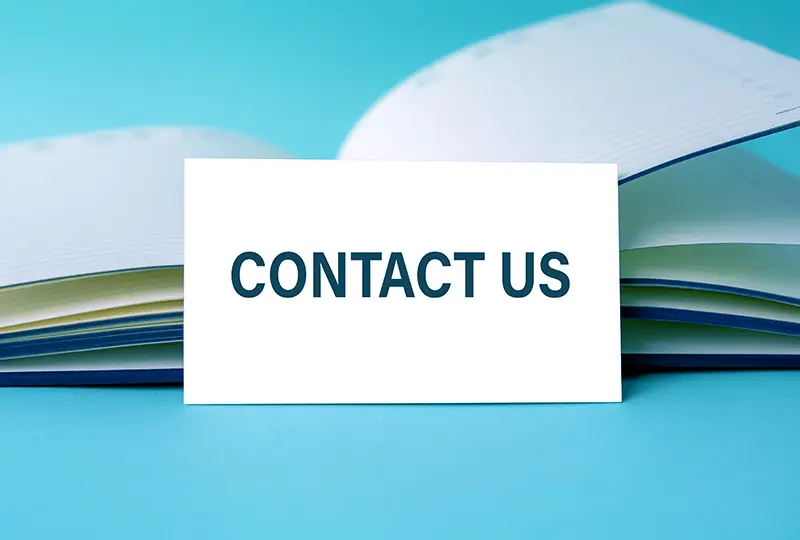 contact-us contact us sign sitting on calendar book